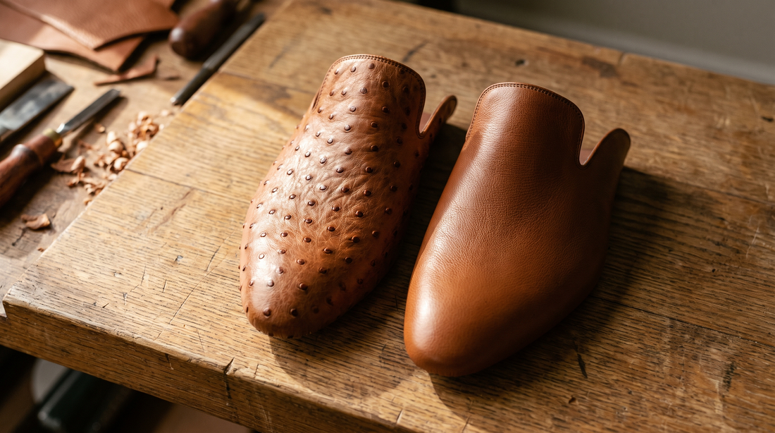 Two boot vamps on a bootmaker's bench: full-quill ostrich with raised follicle bumps beside smooth ostrich with a fine grain