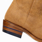 Close-up of The Shoal Creek golden tan heel with the blue heel stripe