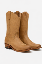 The Shoal Creek tan suede pair, angled view on a soft grey studio backdrop