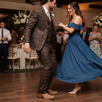 Man in a plaid suit and The Shoal Creek tan boots dancing at a wedding reception