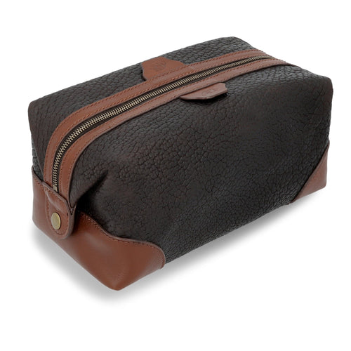 The Heritage Dopp Kit in dark brown bison with tan trim, angled view.