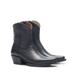 The Trinity ankle boot in black leather, angled pointed-toe pair on a white background