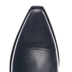 Close-up of the pointed toe on The Trinity boot in black leather, showing grain texture