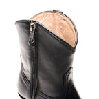 Close-up of the back zipper and tan leather lining on The Trinity boot in black