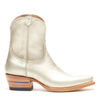Straight side profile of a single Trinity boot in metallic champagne leather
