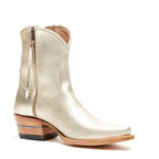 Angled side view of a single Trinity boot in champagne leather, zipper tab hanging