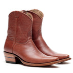 The Trinity ankle boots in cognac-brown leather, angled pair on a white background