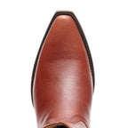 Close-up of the pointed toe on The Trinity boot in cognac-brown leather