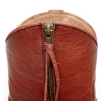 Close-up of the zipper and collar seam on The Trinity boot in cognac-brown leather