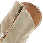 Close-up of the zipper pull and stitched collar on The Trinity boot in champagne