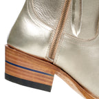 Close-up of the heel on The Trinity boot in champagne leather with its blue stripe