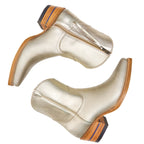 The Trinity ankle boots in metallic champagne leather, viewed directly from above