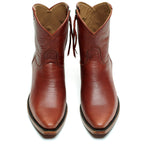 Front view of The Trinity ankle boots in cognac-brown leather on a white background