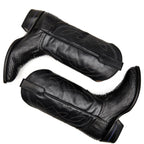 Overhead crossed pair of The 6th Street black python boots on white.