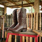 The 6th Street brown boots standing on a red sawhorse in a barn of bats.