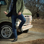 Man leans on a vintage truck in jeans and The 6th Street black python boots.
