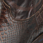 Angled close-up of the brown leather-to-python seam on The 6th Street shaft.