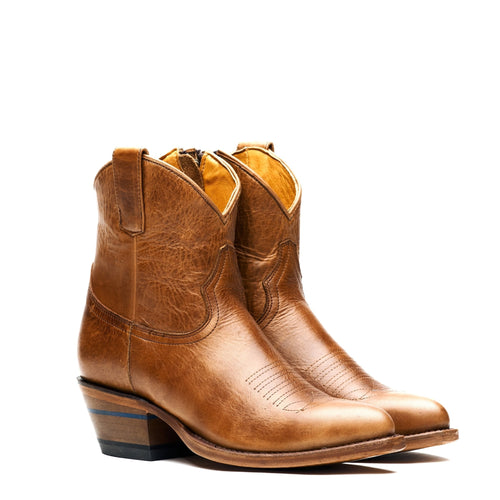 The Rainey ankle boots in cognac leather, three-quarter pair view on white.