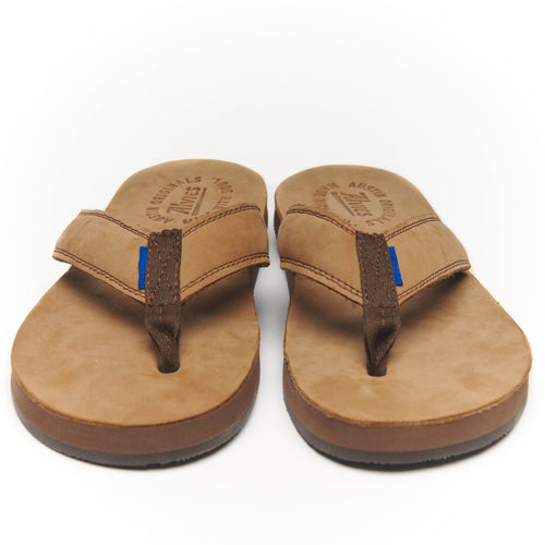Front-facing pair of The Riverside flip-flops in tan leather with dark toe straps.